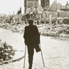 A wounded person in a destroyed city